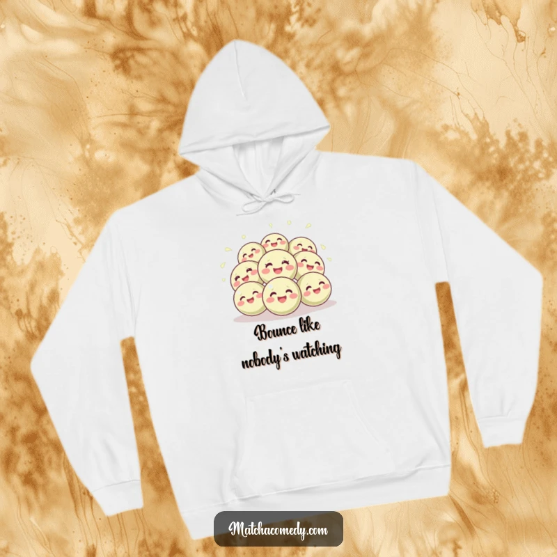 Funny hoodie displaying a delightful cluster of round, giggling matcha balls bouncing with pure, unadulterated joy and energy.