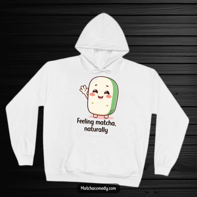 Funny matcha roll character doing a silly wave on a soft, warm hoodie, perfect for cheerful comfort.
