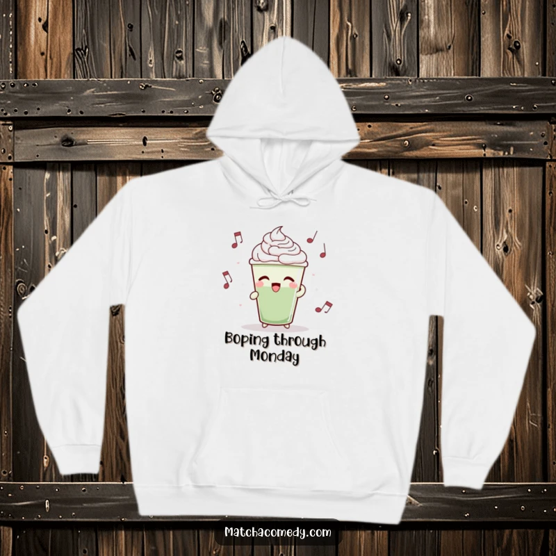 Funny matcha latte cup rhythmically bobbing to music, printed on a soft hoodie for cozy vibes.