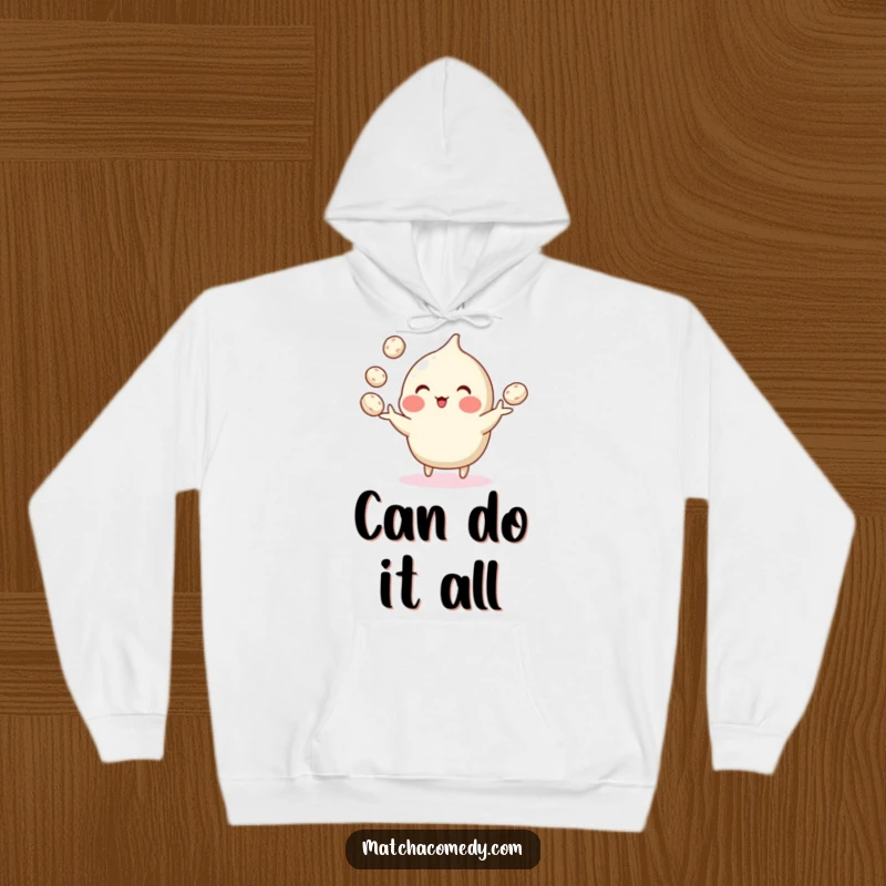Funny hoodie showing a sweet matcha confection juggling multiple tiny mochi balls with impressive dexterity and a cheerful expression.