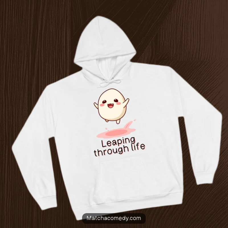 Funny Kawaii Matcha Mochi Leap Hoodie: A warm hoodie featuring a joyful matcha mochi in mid-leap, leaving powder.