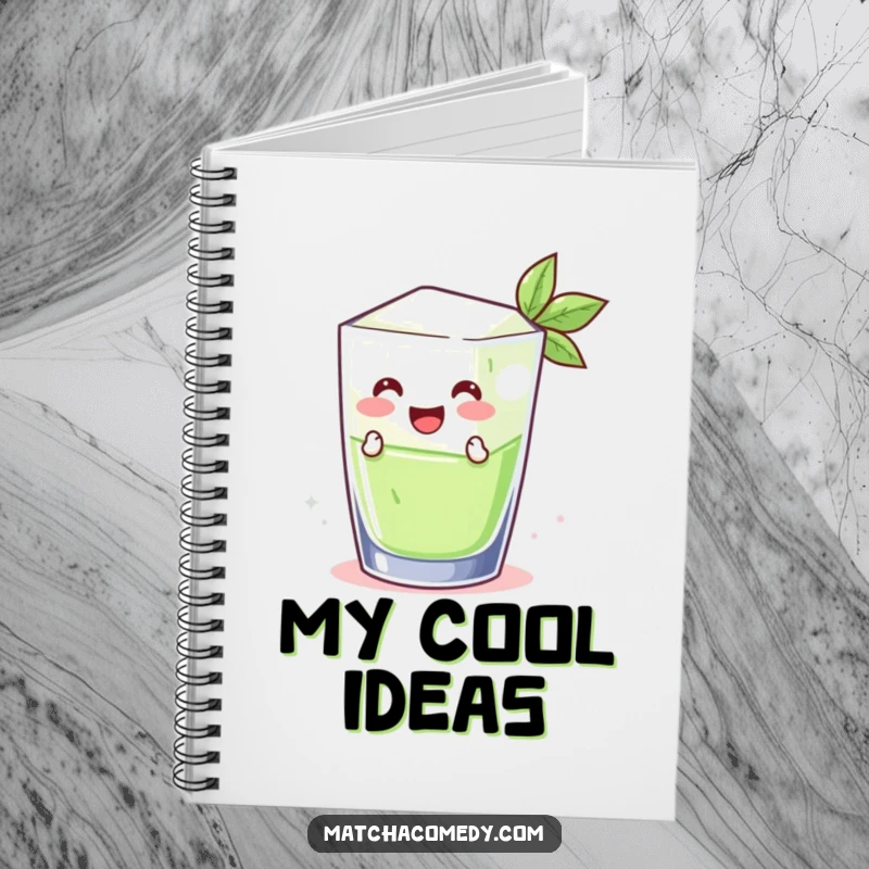 Funny smiling matcha ice cube leaping from a glass, gracing the cover of a notebook. Ideal for keeping cool notes.