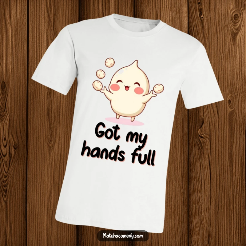 Funny t-shirt depicting a matcha confection performing an impressive juggling act with small mochi using its tiny hands.